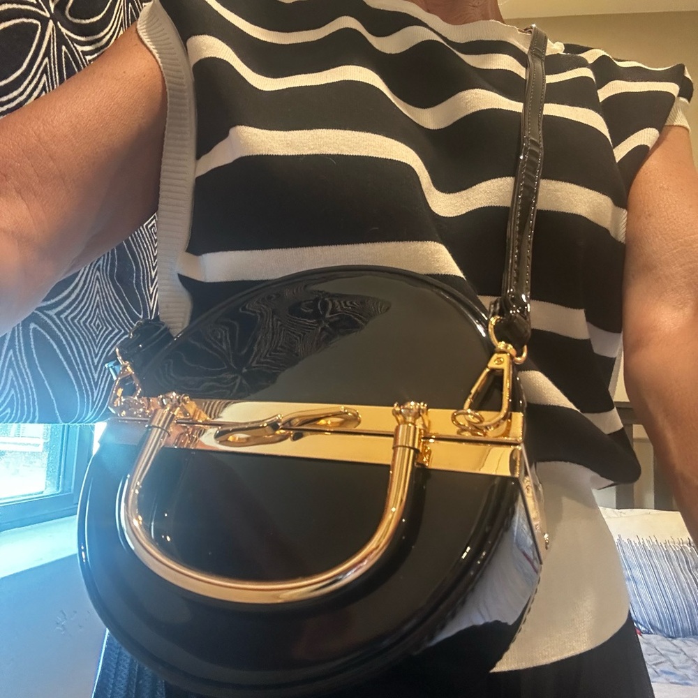 Mezon FASHION ROUND FRAMED BLACK PATENT BOX
BAG WITH LONG STRAP & GOLD ACCENTS